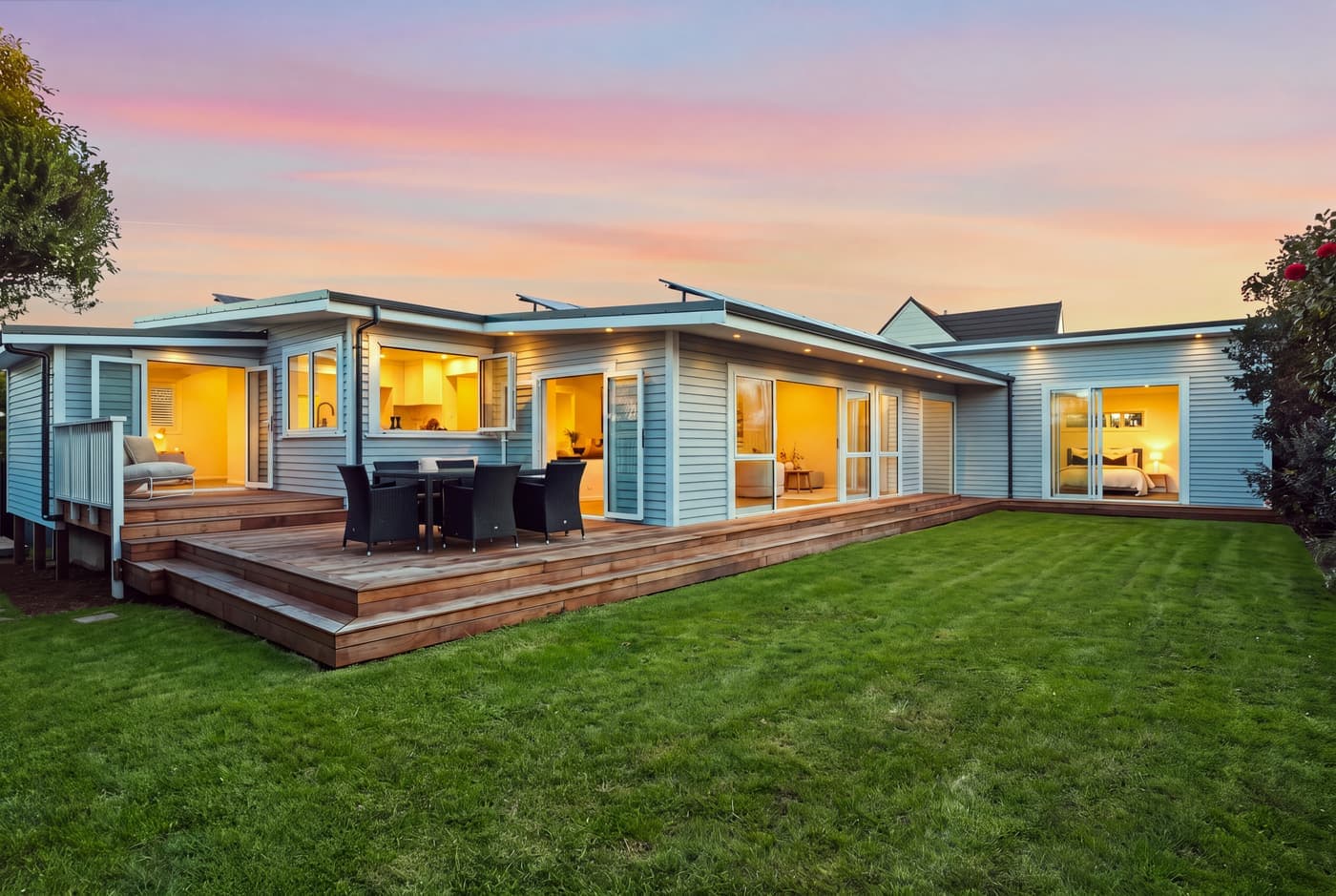 Weatherboard home and lawn at twilight