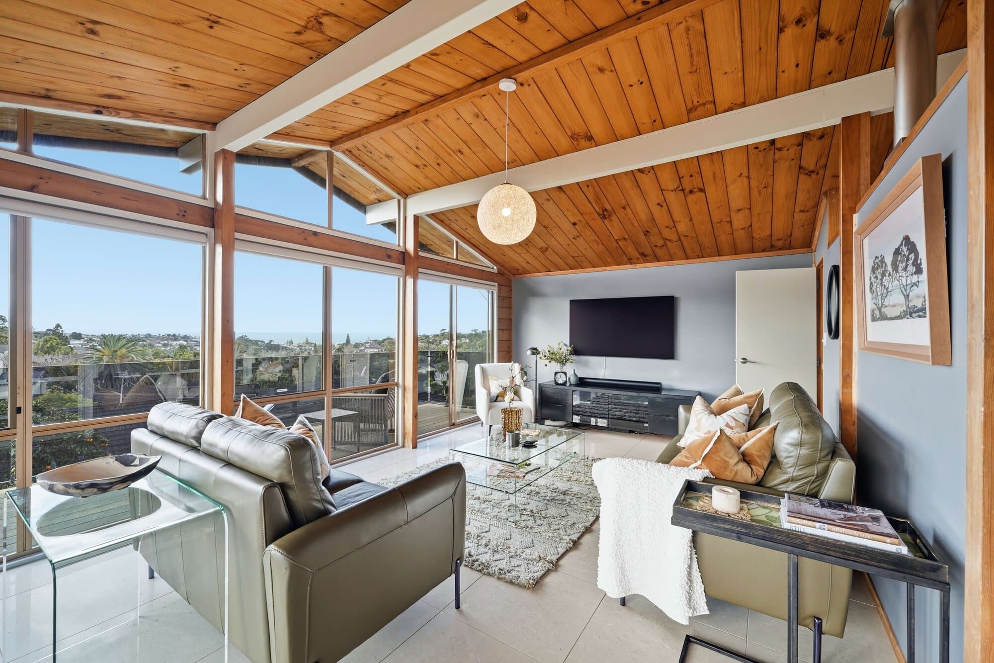 Living room with a vaulted timber ceiling and sea views
