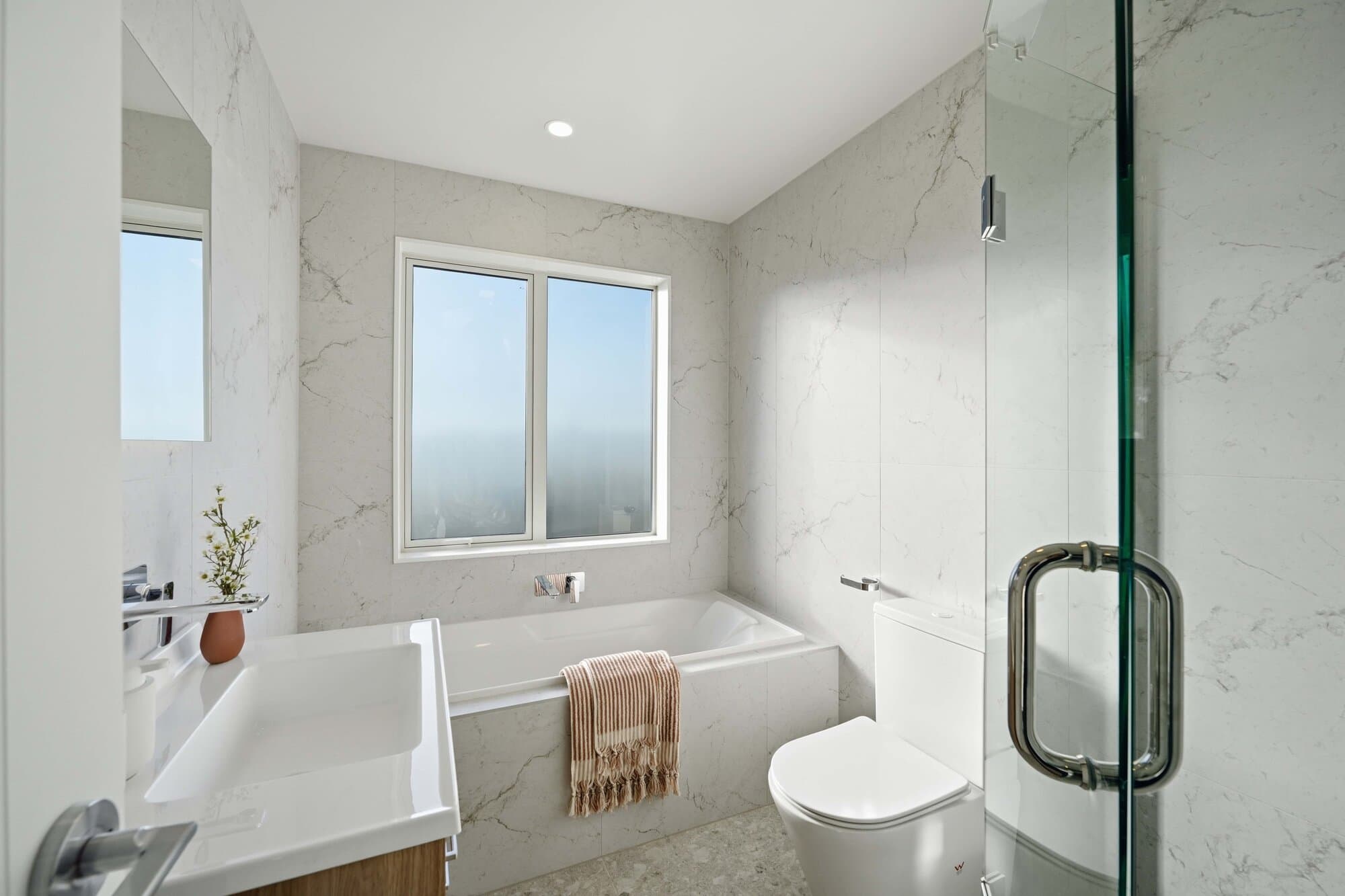 Bathroom with a freestanding tub finished in marble