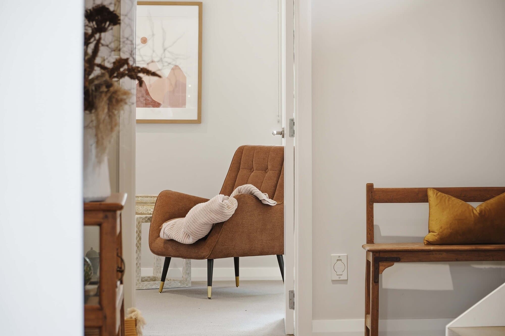 Entry hallway with an armchair and artwork