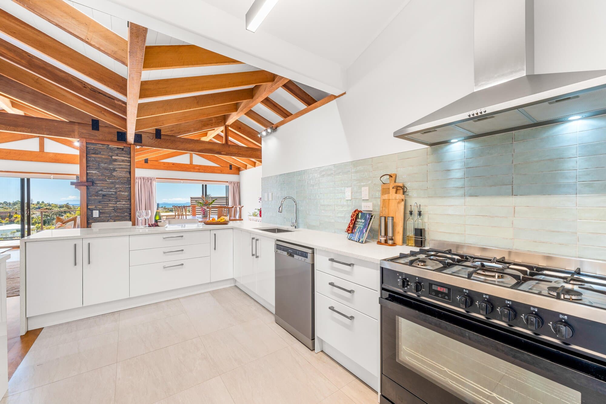 Kitchen with timber beams and a gas range