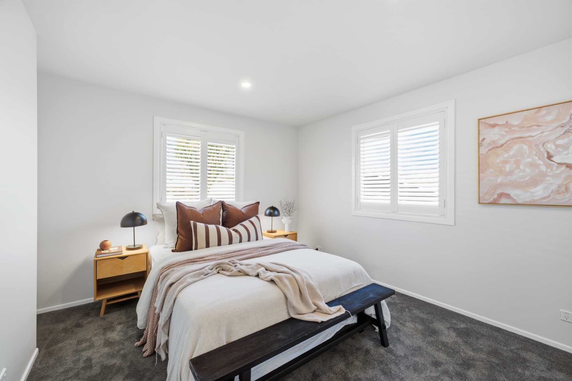 Bedroom with plantation shutters and timber bedsides